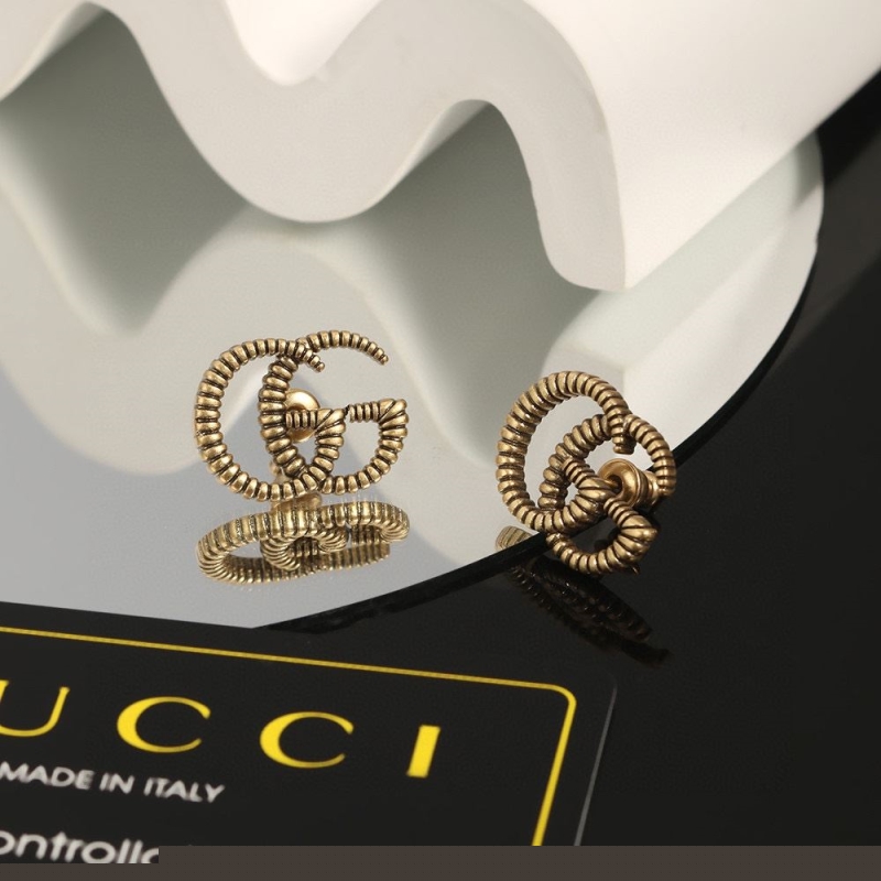 G*u*i earrings